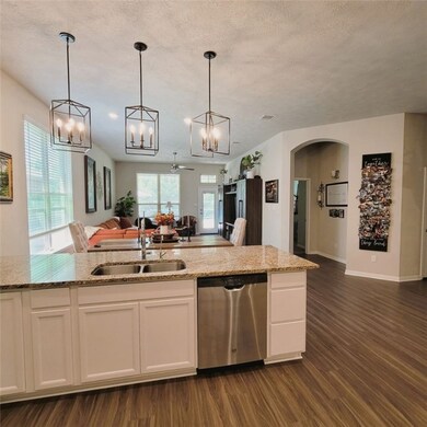 Kitchen featuring stainless steel dishwasher, open