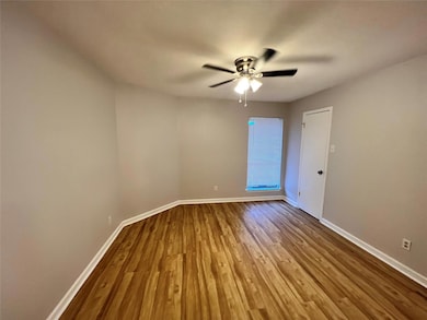 Spare room featuring baseboards, a ceiling fan, an