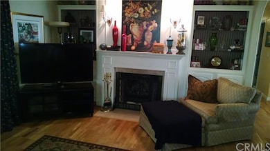 Living room with built-ins, wood burning fireplace