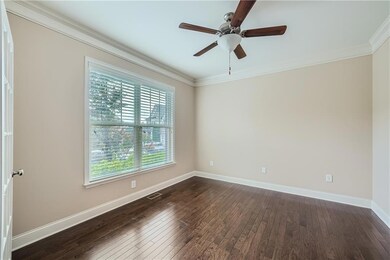 Unfurnished room featuring crown molding, dark woo