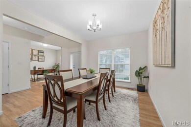 Dining area featuring light wood-style flooring and a chandelier