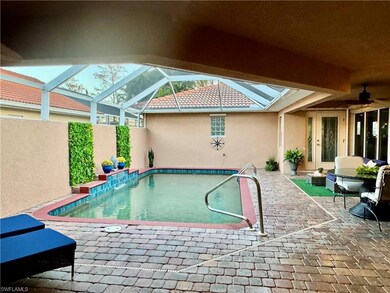 View of swimming pool with ceiling fan, a lanai, a
