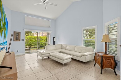 Living room with baseboards, high vaulted ceiling,
