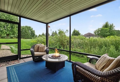 Enjoy the peaceful natural backdrop in your newer screened in porch!  Plus, a convenient screen door for easy access to your backyard.