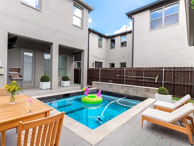View of pool featuring a patio, a fenced backyard, and a grill