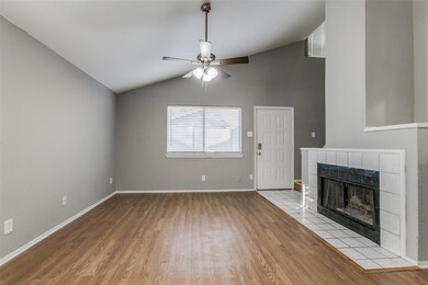 Living room featuring ceiling fan, light hardwood 