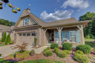 Lovely landscaping and a relaxing covered front porch give this home wonderful curb appeal.