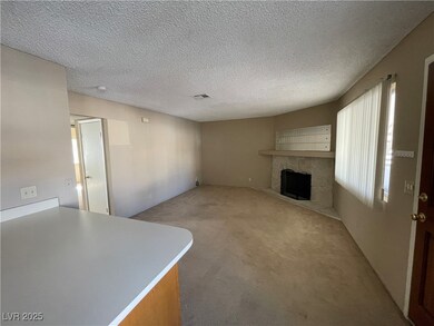 Unfurnished living room with a stone fireplace, ca