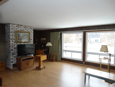 Laminate floor with large windows in the living room.