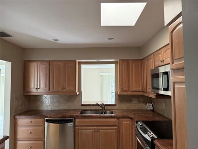 Spacious and updated kitchen with skylight.