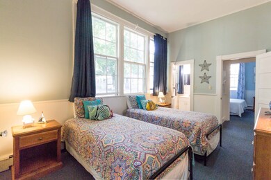 Large bedroom with set of twins.