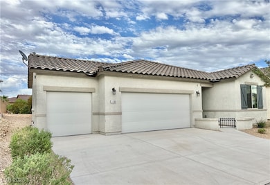 Mediterranean / spanish home featuring an attached garage, stucco siding, driveway, and a tile roof