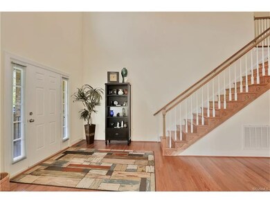 Large two story open foyer with Hardwood Floors
