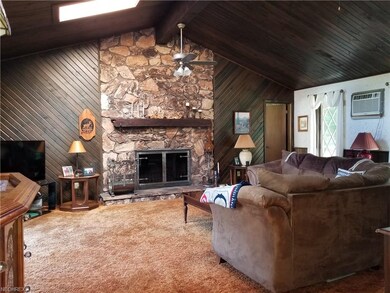 Dynamic Great Room with Vaulted Ceilings and Stone Fireplace