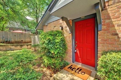 Property entrance with brick siding and fence
