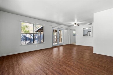 Unfurnished living room featuring dark wood-type 