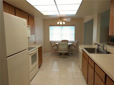 Bright eat in, galley kitchen features white whirl