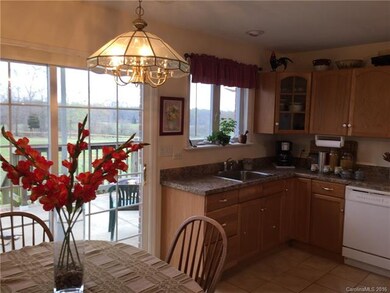 Eat in kitchen looks over a large deck and pasture