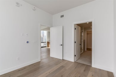 Empty room with visible vents, baseboards, and li