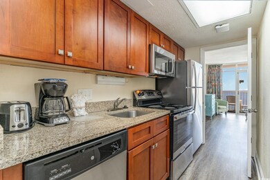 Kitchen with light stone counters, stainless steel