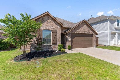 View of front facade with a garage and a front lawn