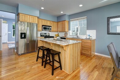 Spacious granite Kitchen with rich wood cabinets. Pull up to center island for morning coffee!