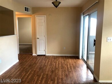 Spare room with baseboards, visible vents, and woo