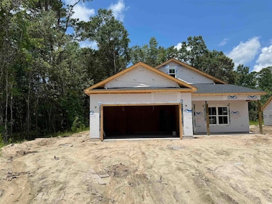 Unfinished property with an attached garage and driveway