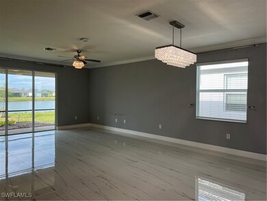 Spare room with baseboards, visible vents, a water