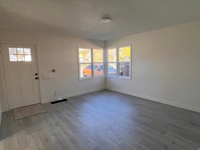 Entryway featuring a textured ceiling, healthy amount of natural light, and wood finished floors