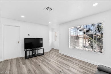 Unfurnished living room with recessed lighting, and baseboards