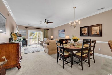 Dining room with crown molding, ceiling fan with n