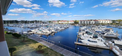 Dock featuring view of marina and a water view