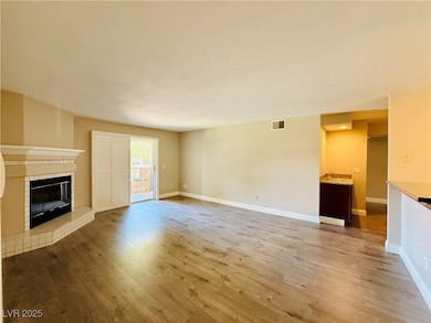 Unfurnished living room with wood finished floors