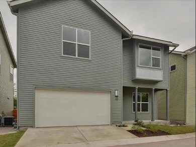 View of front of house featuring a garage, drivew