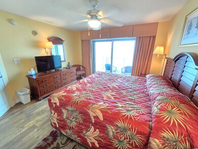 Bedroom featuring access to exterior, light hardwo