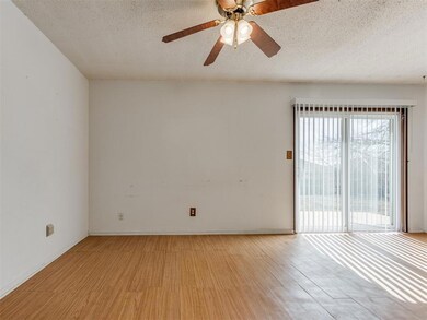 Unfurnished room featuring ceiling fan, a textured