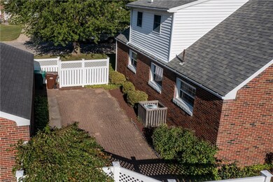 BRICK PATIO BETWEEN HOUSE AND GARAGE/ A.C. UNIT IN