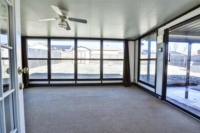 Unfurnished sunroom featuring ceiling fan