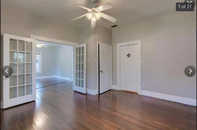 Spare room with baseboards, wood finished floors,