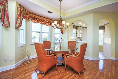 Dining area with crown molding, a raised ceiling,