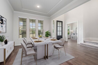 Formal dining with crown molding. Virtually staged