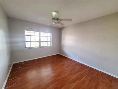 Bedroom offers laminate hard wood flooring and gre