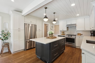Quartz counters, shiplapped ceiling, open shelving