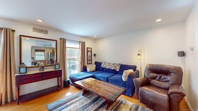 Spacious living room with hardwood floors.