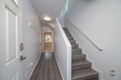 Front door facing stairs