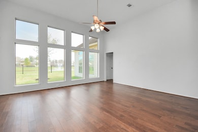Family room w/ floor to ceiling windows w/ Lake vi