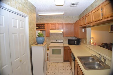 Kitchen with white appliances lots of counter and 