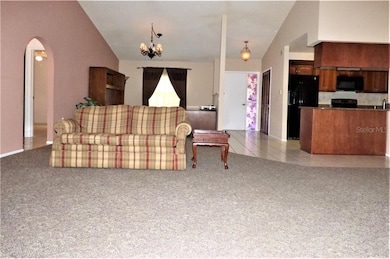 Living room from west wall towards dining area/off