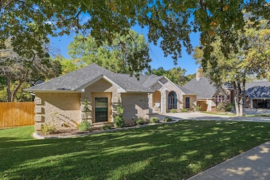 View of front of property with brick siding, a chimney, and stone siding